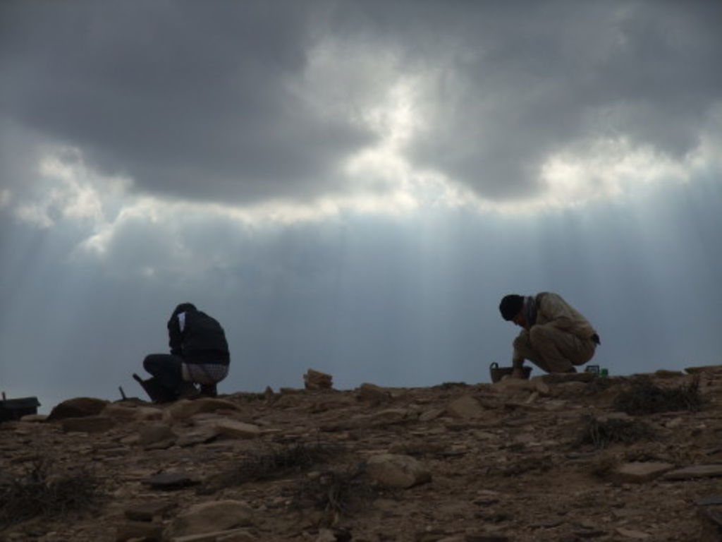 Fig. 18: Nadine Bürkle and Will Kennedy working while the storm rises behind them.