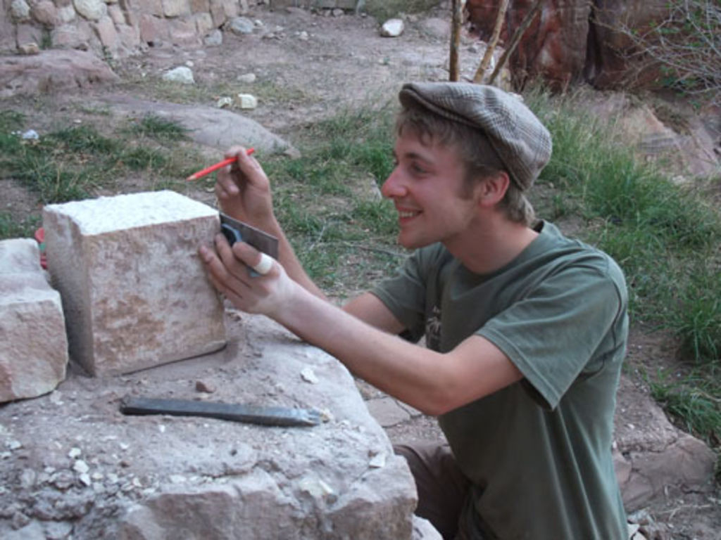 Fig. 31: Robert Haas-Zens applying his professional masonery skills on a solid sandstone block.
