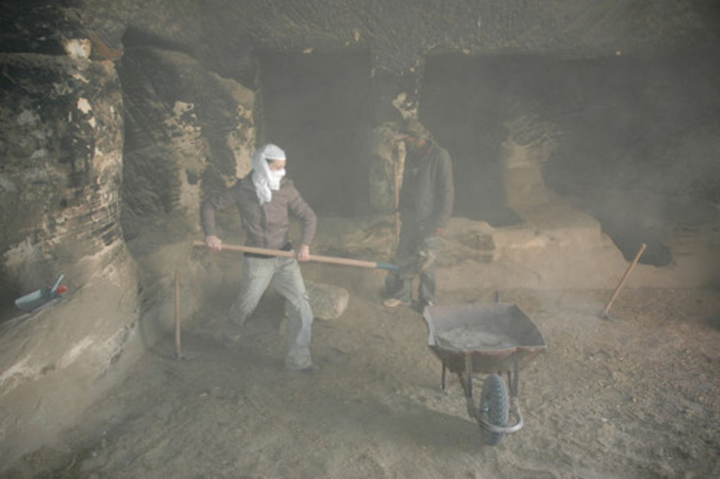 Fig. 63: Aurélie Guet fearlessly cleaning the goat and donkey shit in the cave tomb of the Aslah complex.