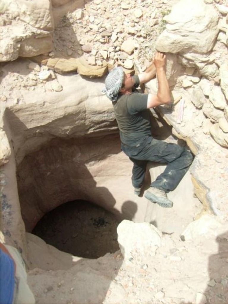 Fig. 74: Stephan Schmid doing his early morning gym, trying to climb out of a huge rock-cut cistern.