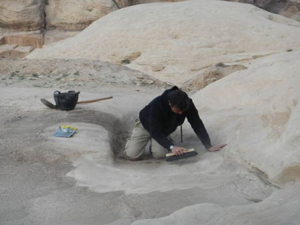 Fig. 63: Laurent Gorgerat cleaning the rock cut structures near the Aslah triclinium.
