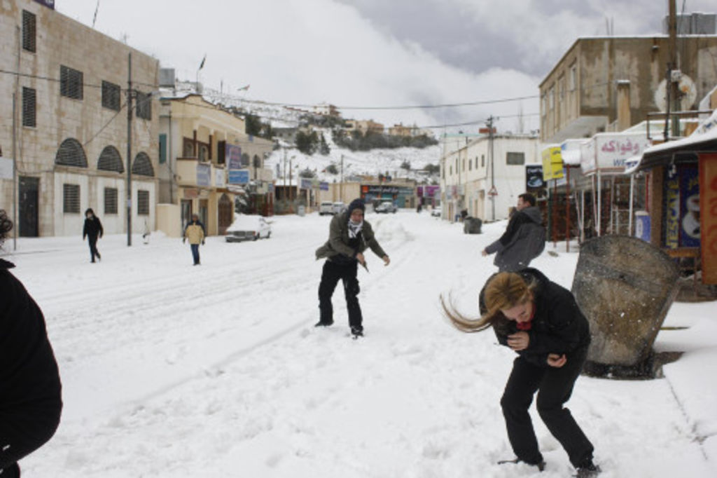 Fig. 3: While waiting for the second car trip to Petra, the students enjoyed themselves during a snowball battle in the main street of Shobak