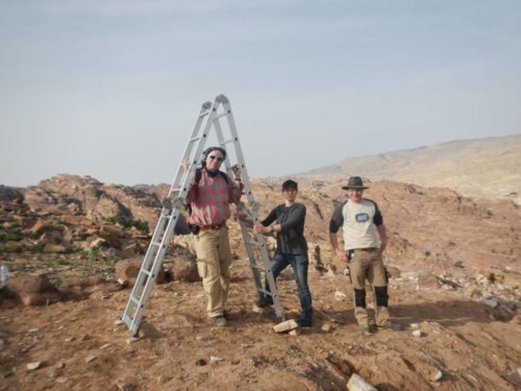 Fig. 10: Christoph Schneider, Sophie Horacek and Raphael Eser (from left to right) preparing the ladder for taking a picture