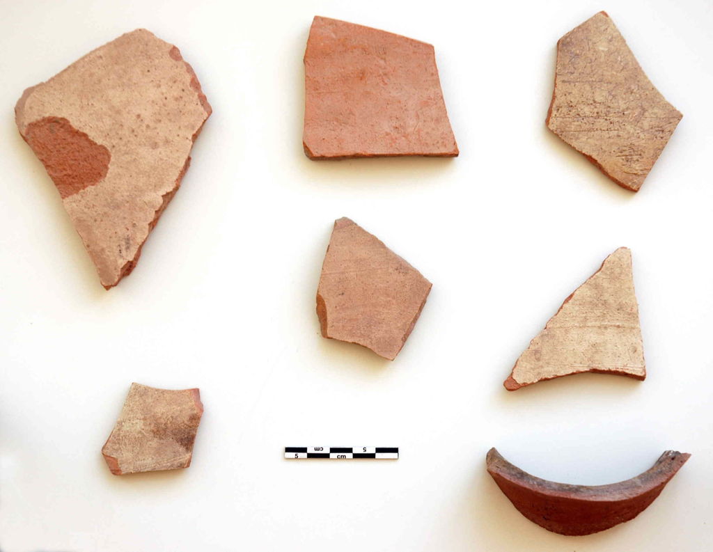 Fig. 19: Wadi Farasa East, fragments of transport amphorae from inside the rock-cut triclinium in SW-corner of the complex (photo: S. G. Schmid)